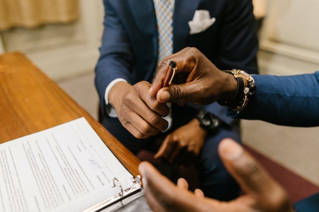 Two people signing a contract