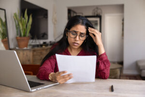 frustrated woman reading letter